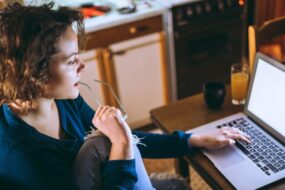 Image to show a lady writing on her laptop