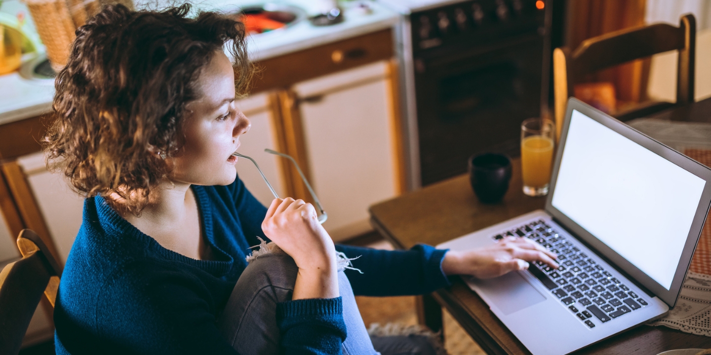 Image to show a lady writing on her laptop