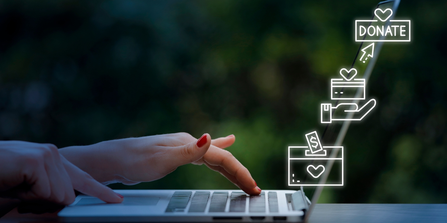 an image showing a laptop and love for a charity donation