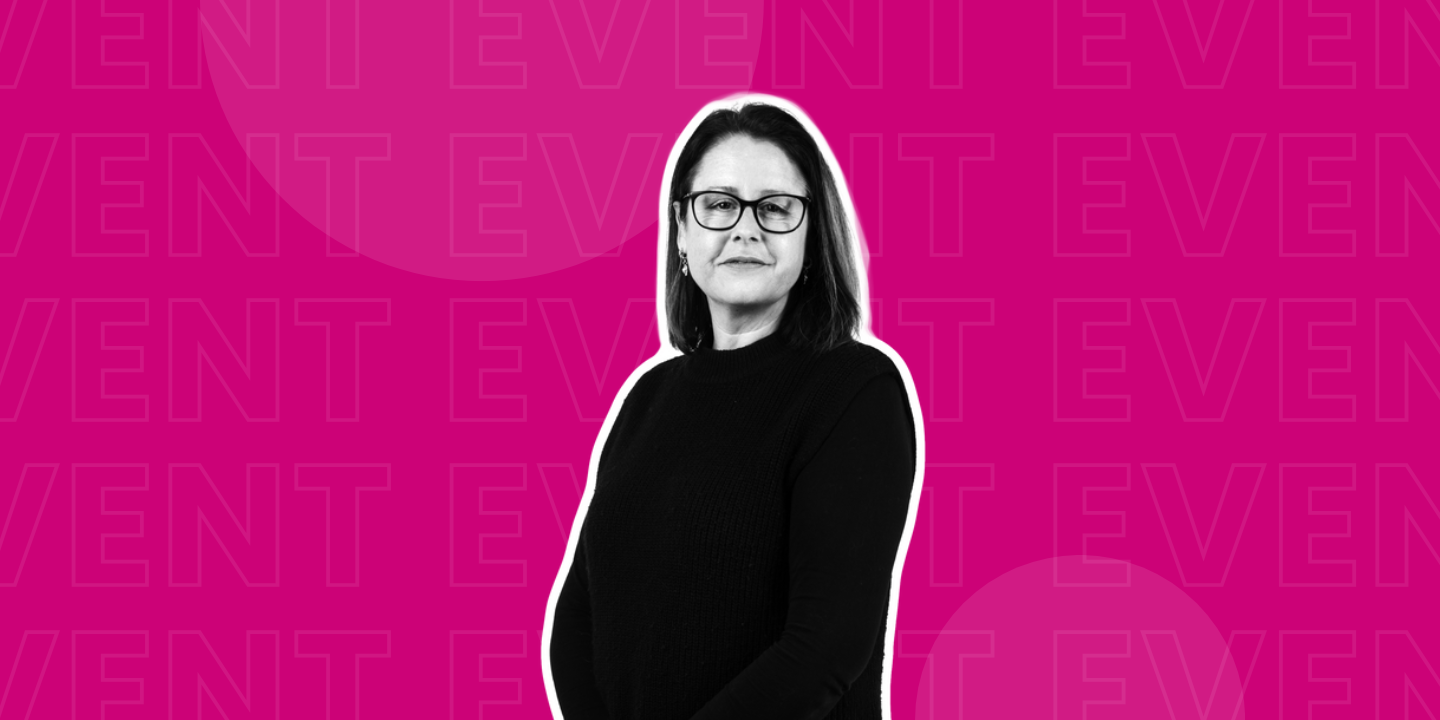 Black and white photo of a woman in front of a pink background
