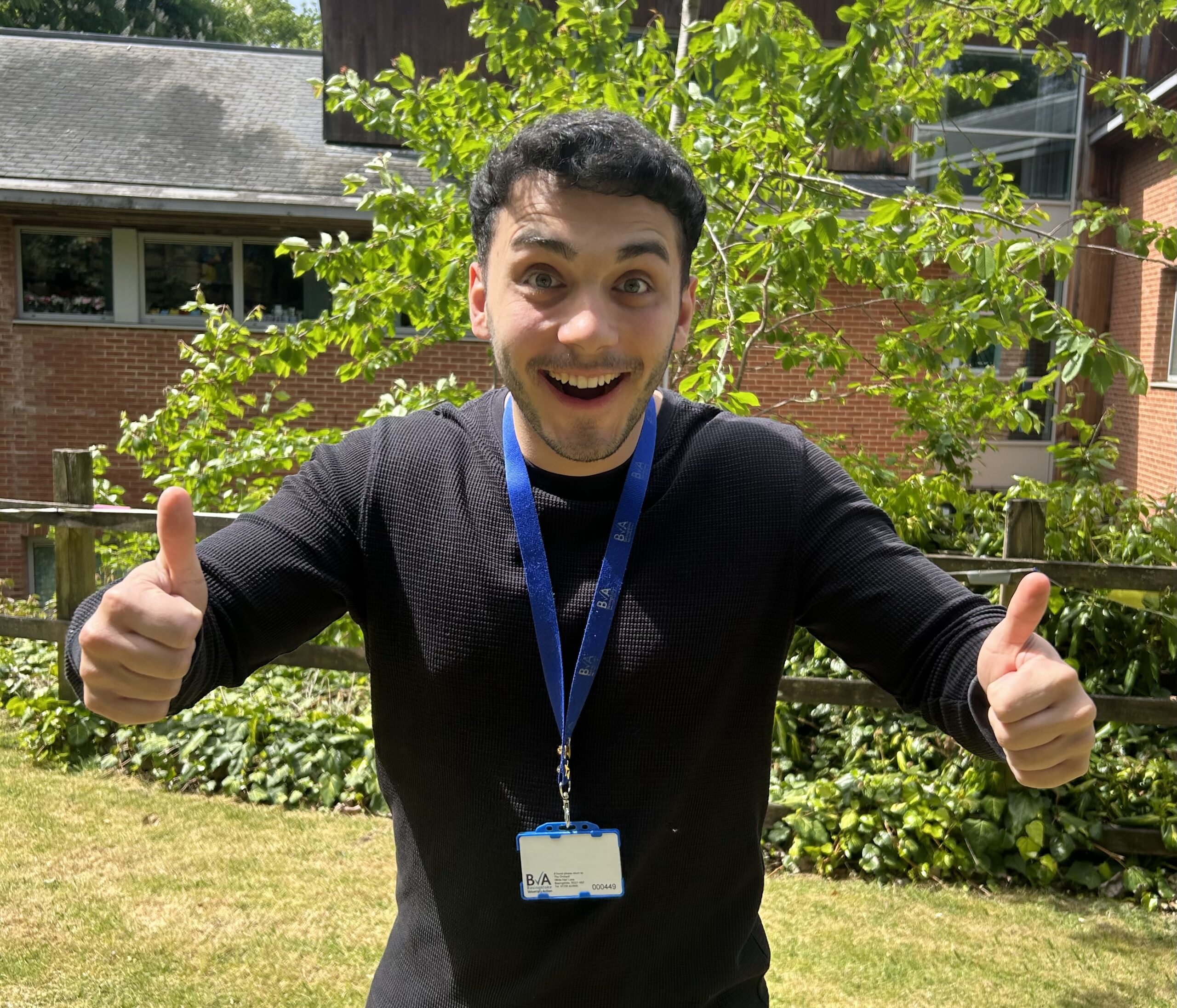 Photo of a man with his thumbs up