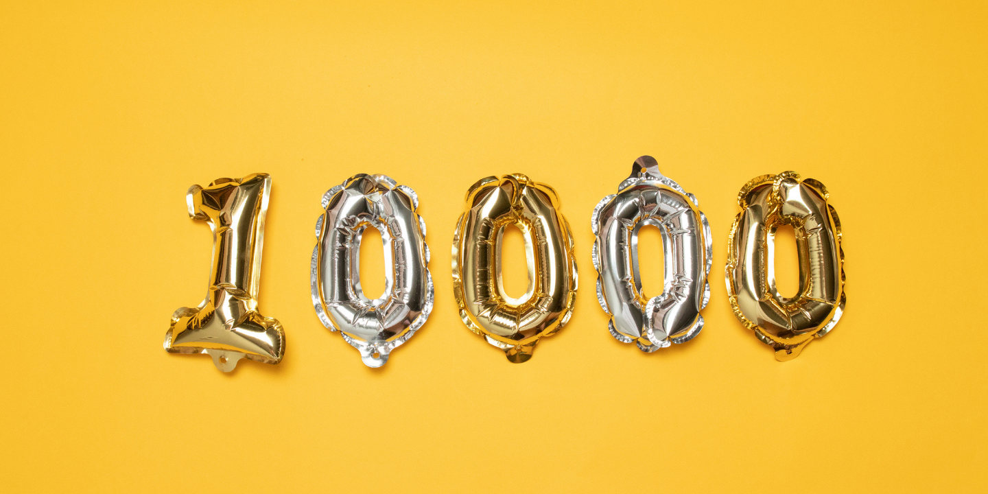 balloons in the shape of 10,000 on a yellow background